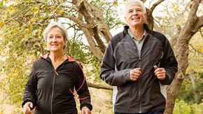 elderly couple walking in the forest